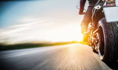 motorcycle riding in to the sunset